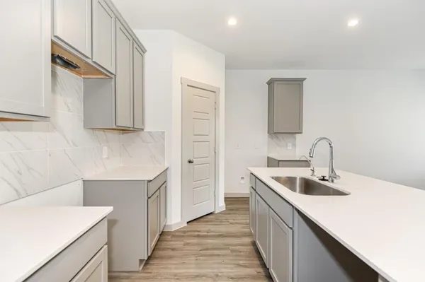 a kitchen that has a sink and a stove in it