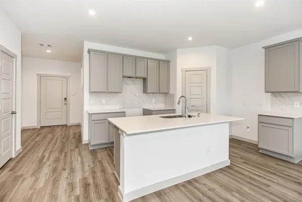 a kitchen with a sink stove and cabinets