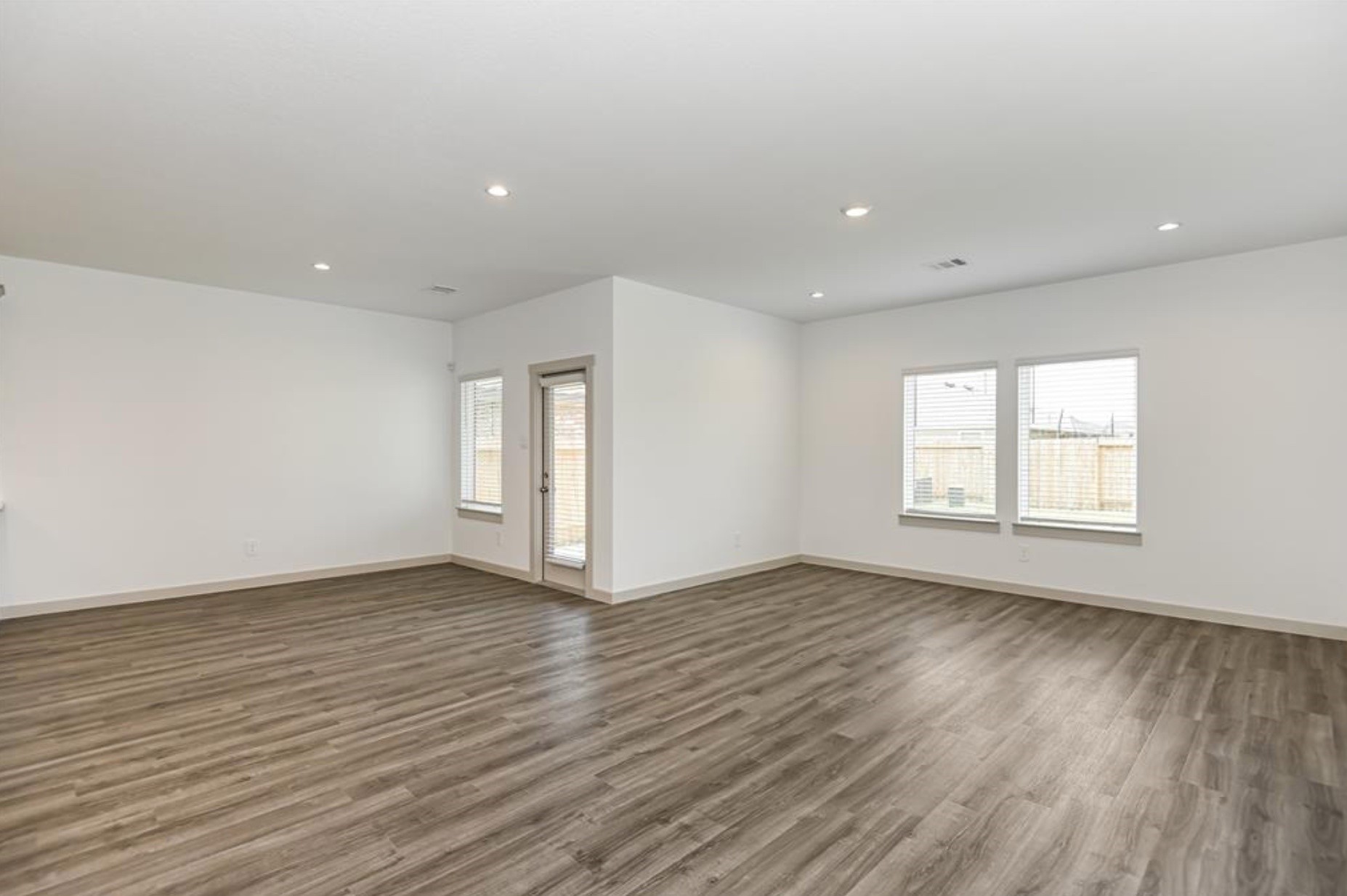 7918 Brumly Lane Rosharon, TX 77583 - Photo 8 of 34 a view of an empty room with wooden floor and a window