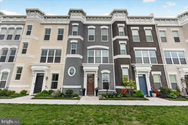 a front view of a residential apartment building with a yard
