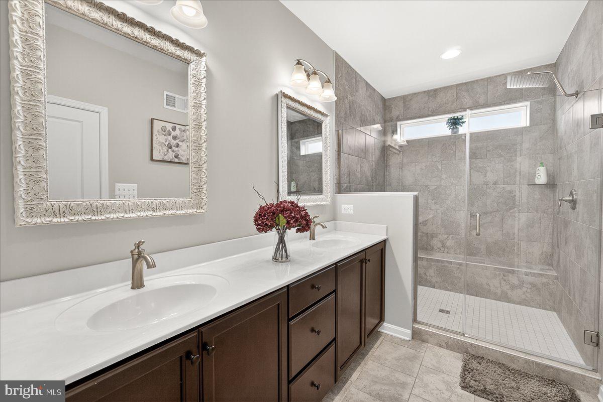 1094 Holden Road Frederick, MD 21701 - Photo 27 of 92 a bathroom with a shower sink double vanity and mirror