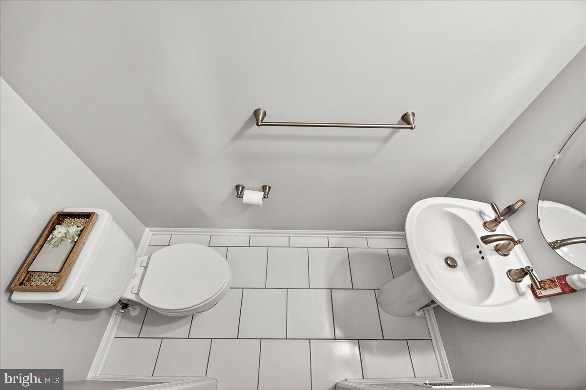 1094 Holden Road Frederick, MD 21701 - Photo 35 of 92 a bathroom with a sink mirror and toilet