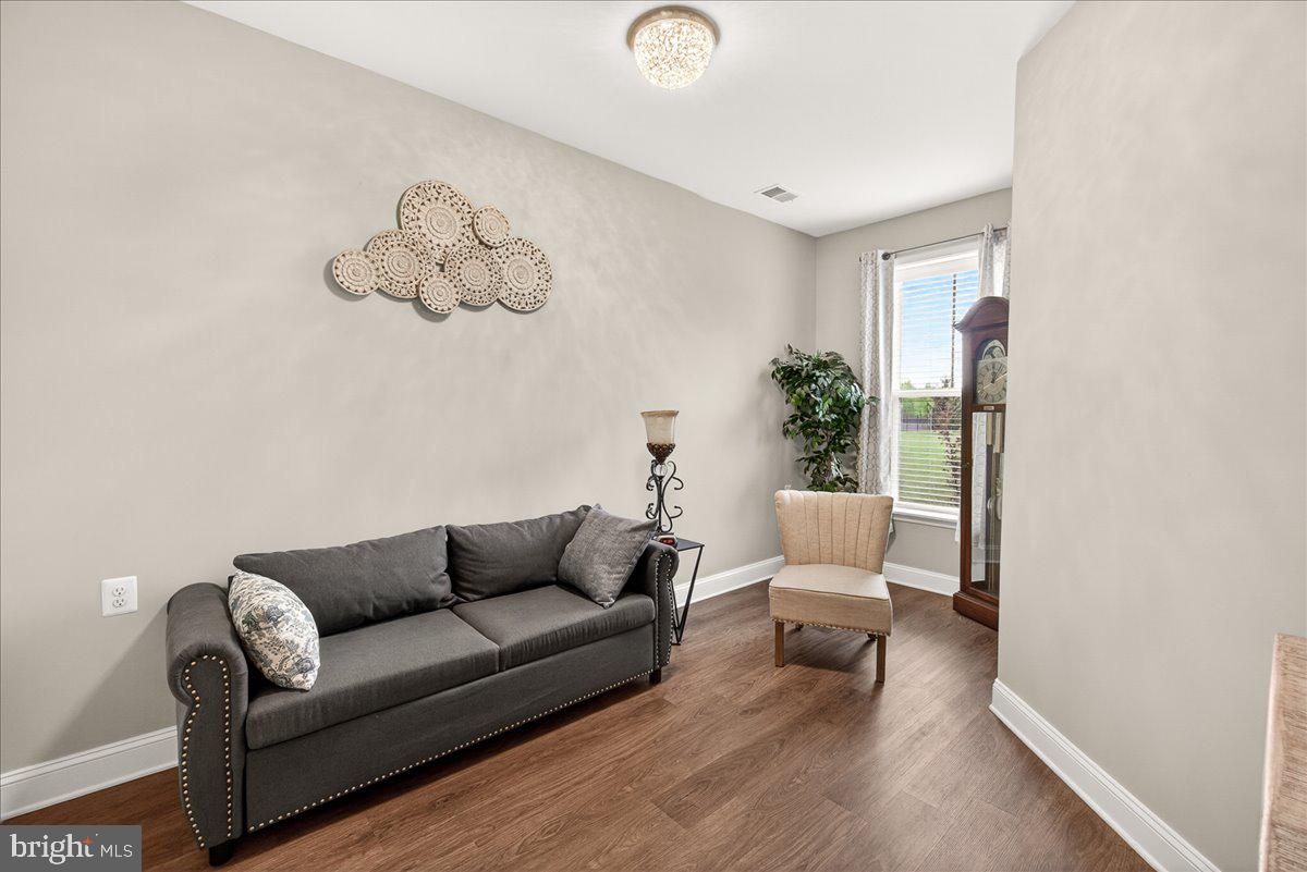 1094 Holden Road Frederick, MD 21701 - Photo 40 of 92 a living room with furniture and wooden floor