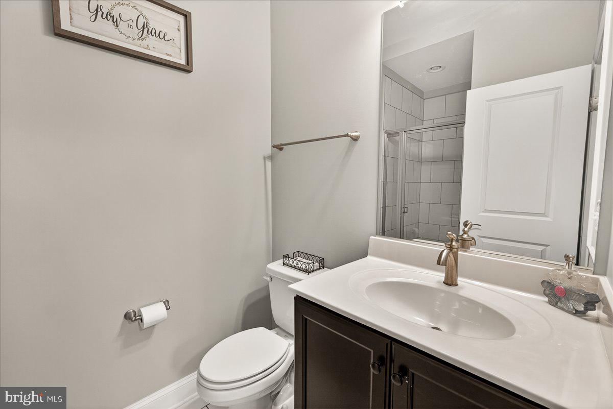 1094 Holden Road Frederick, MD 21701 - Photo 42 of 92 a bathroom with a granite countertop sink toilet and a mirror