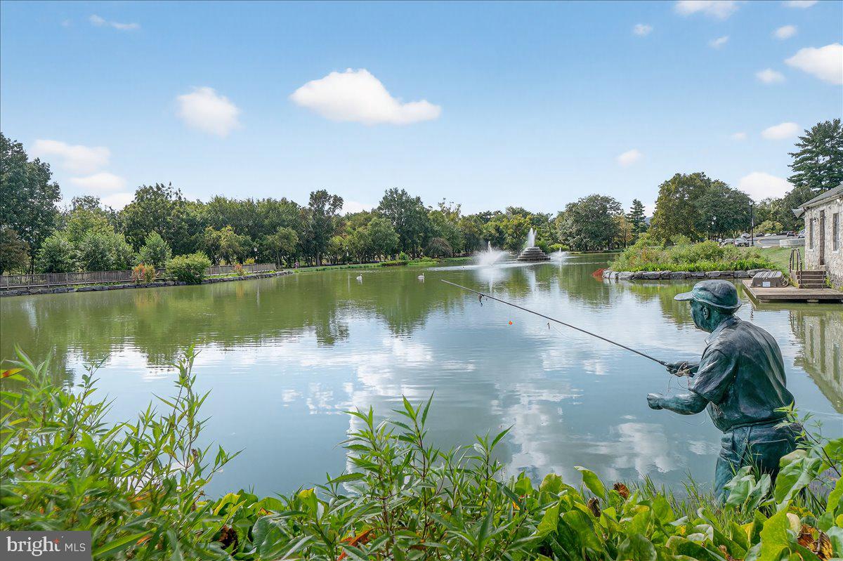 1094 Holden Road Frederick, MD 21701 - Photo 65 of 92 a view of a lake with a yard and trees in the background