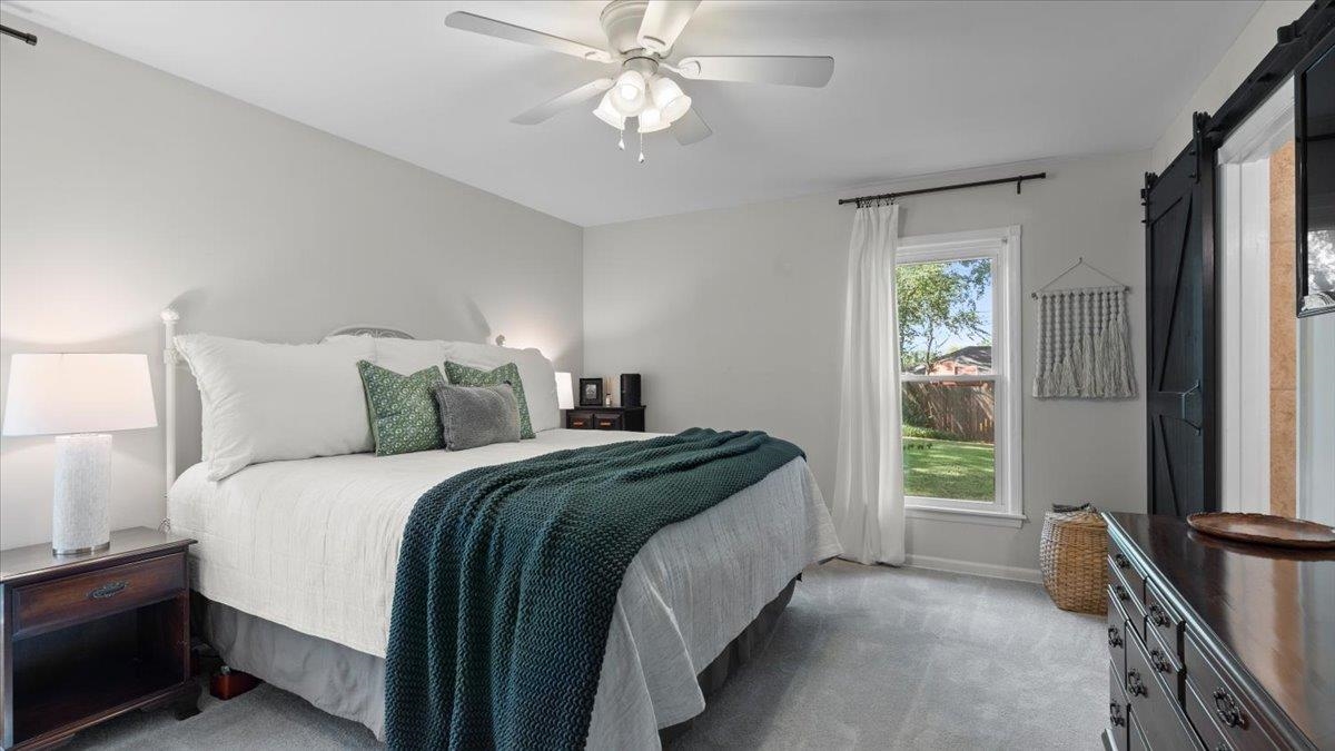 5596 Rich Road Memphis, TN 38120 - Photo 14 of 34 a bed sitting in a bedroom next to a window