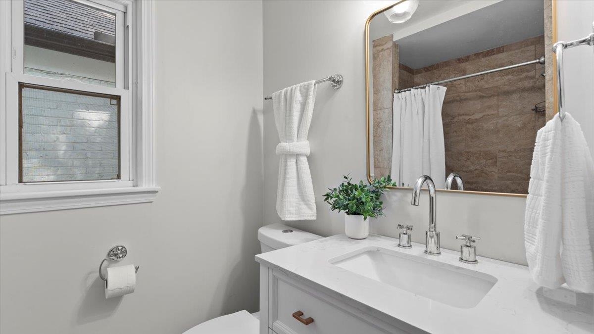 5596 Rich Road Memphis, TN 38120 - Photo 15 of 34 a bathroom with a sink vanity mirror and toilet