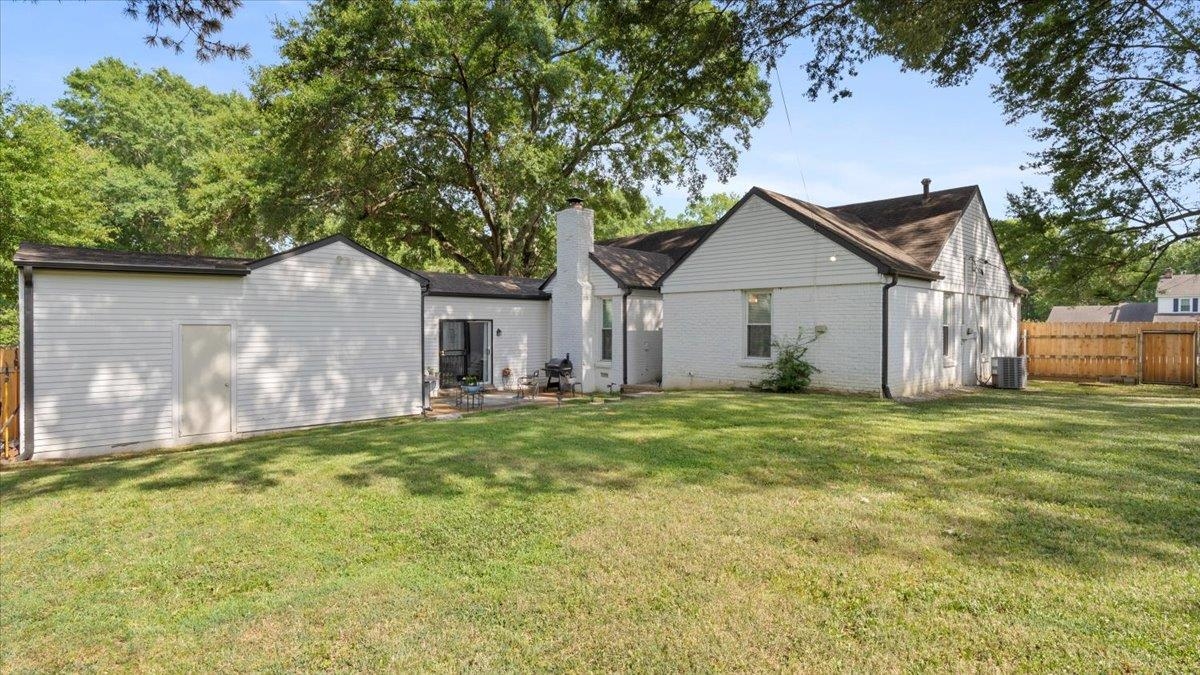 5596 Rich Road Memphis, TN 38120 - Photo 24 of 34 a house with huge green field in front of it