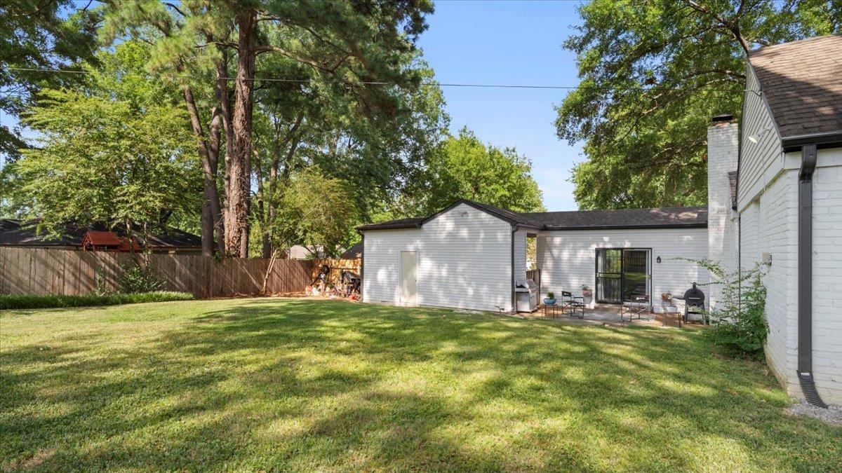 5596 Rich Road Memphis, TN 38120 - Photo 25 of 34 a view of a house with a yard and large tree