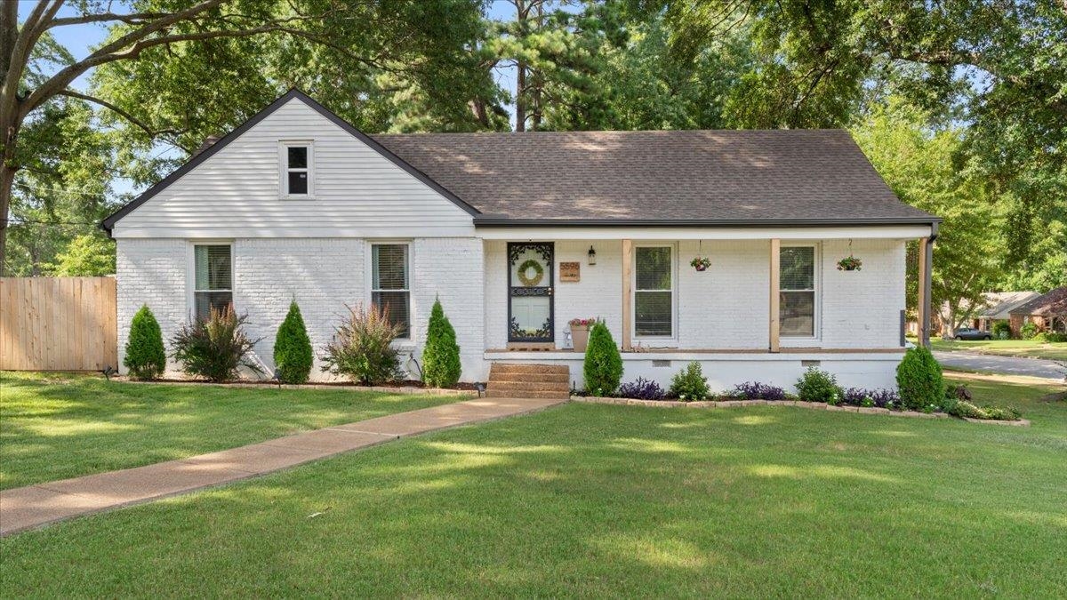 5596 Rich Road Memphis, TN 38120 - Photo 3 of 34 a front view of a house with a yard and garage