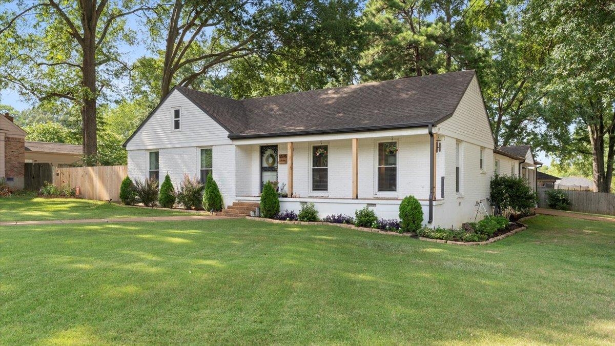 5596 Rich Road Memphis, TN 38120 - Photo 4 of 34 a front view of a house with a yard and garage