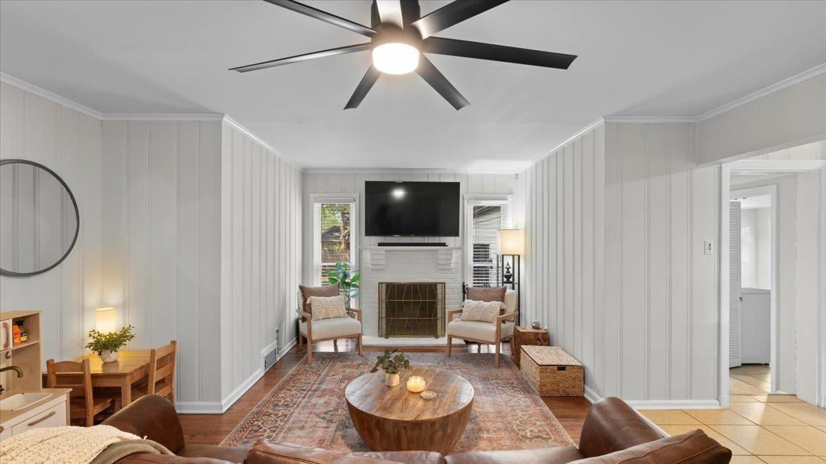 5596 Rich Road Memphis, TN 38120 - Photo 5 of 34 a living room with furniture a fireplace and a flat screen tv