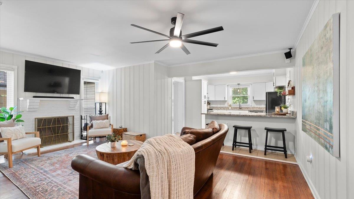 5596 Rich Road Memphis, TN 38120 - Photo 6 of 34 a living room with furniture a fireplace and a flat screen tv
