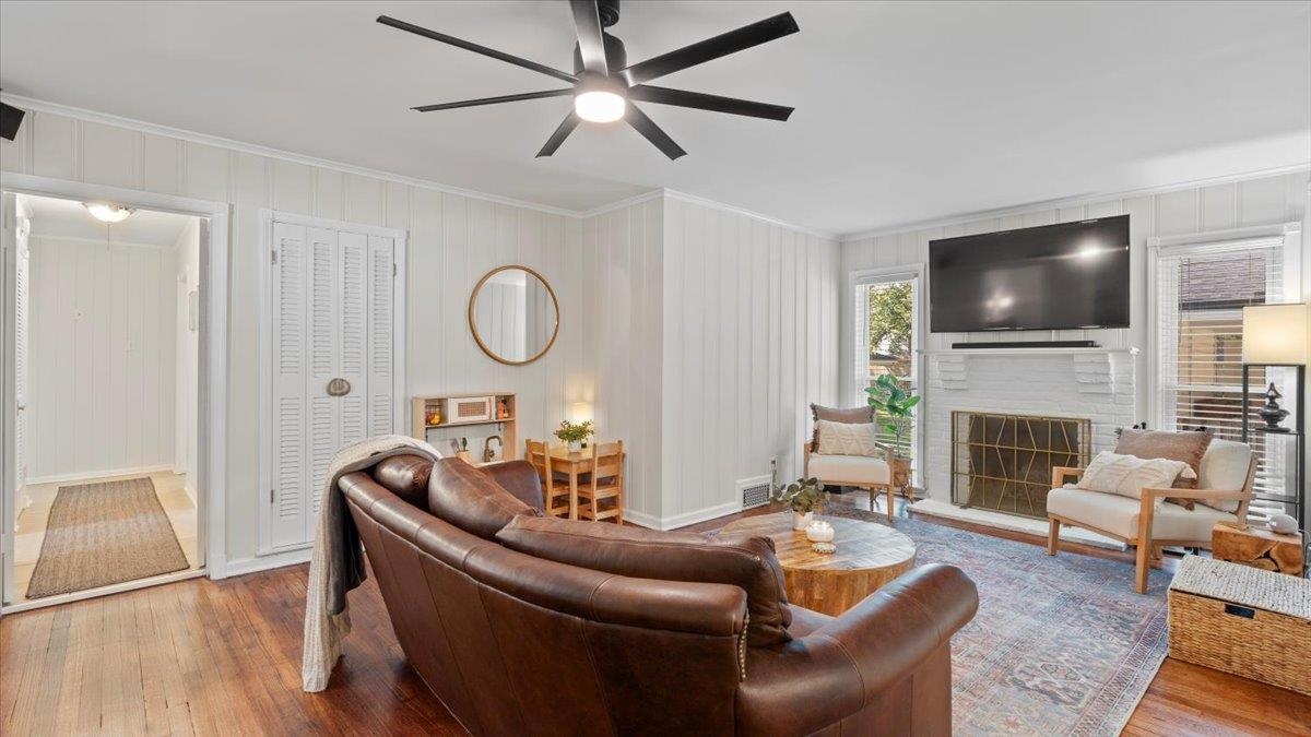 5596 Rich Road Memphis, TN 38120 - Photo 7 of 34 a living room with furniture a fireplace and a flat screen tv