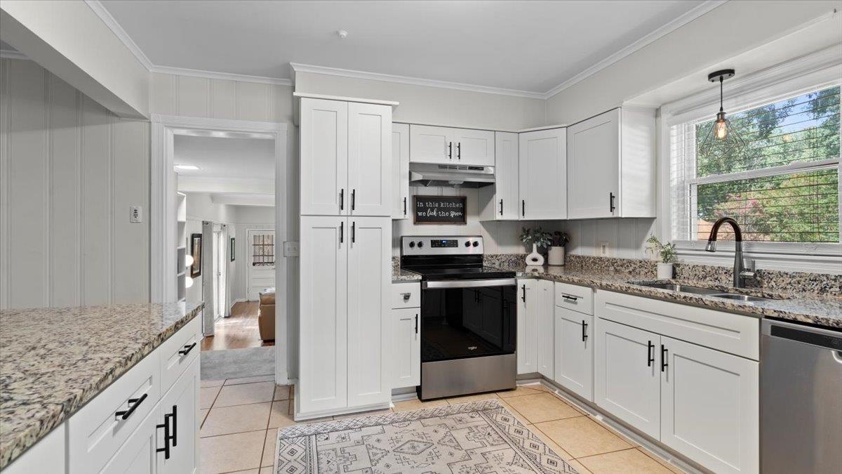5596 Rich Road Memphis, TN 38120 - Photo 9 of 34 a kitchen with stainless steel appliances granite countertop a stove a sink and a refrigerator