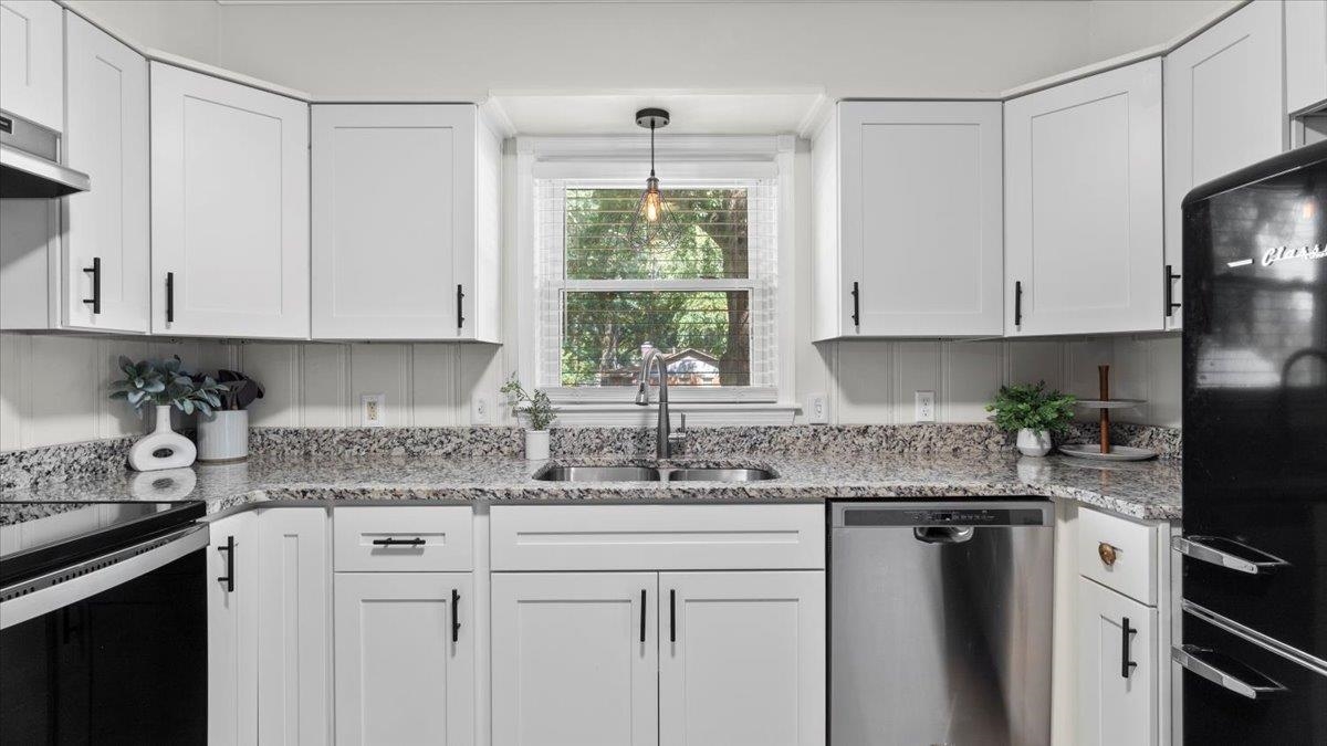 5596 Rich Road Memphis, TN 38120 - Photo 10 of 34 a kitchen with granite countertop white cabinets window and stainless steel appliances