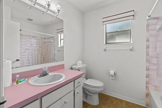 a view of a livingroom with a chandelier fan