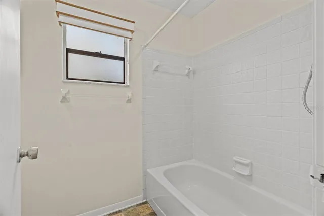 an aerial view of a city with lots of residential buildings ocean and mountain view in back