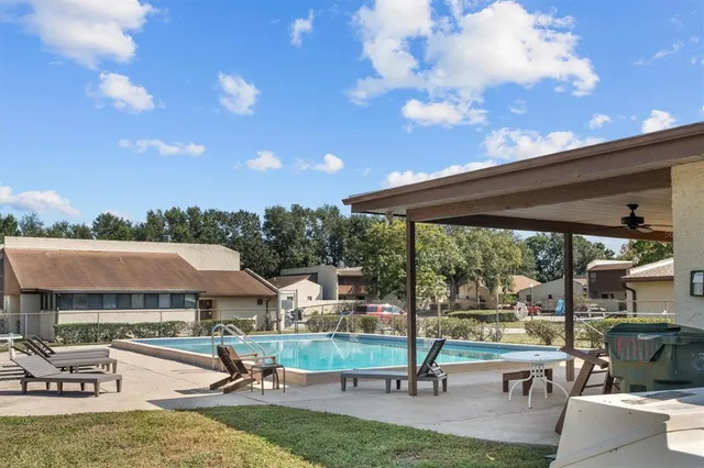a view of swimming pool with seating area and hardwood floor