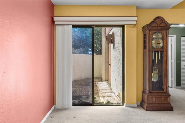 a view of an empty room with a ceiling fan