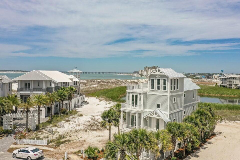 a view of a white building with front of a yard