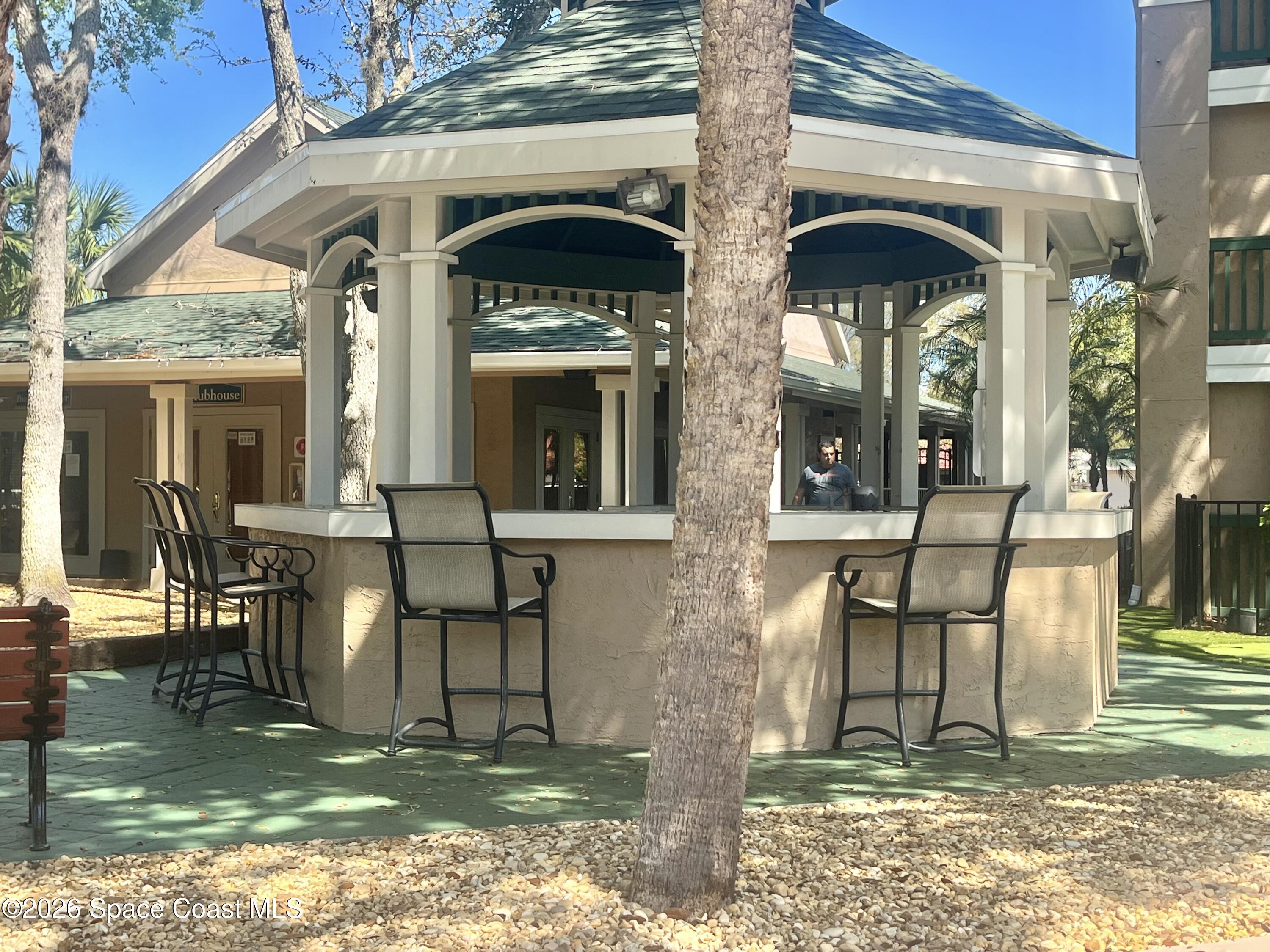 7667 North Wickham Road, Unit 1118 Melbourne, FL 32940 - Photo 20 of 26 a view of a dinning table and chairs in the patio