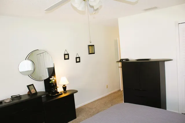 a bedroom with a bed and a mirror