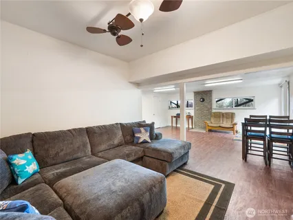 a living room with furniture and wooden floor