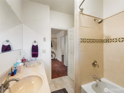 a bathroom with a sink vanity and shower