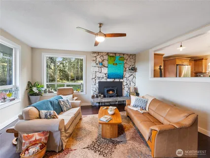 a living room with furniture a fireplace and a large window
