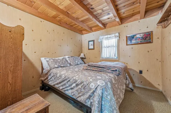 a bed sitting in a bedroom next to a window