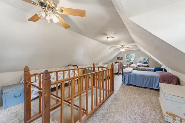 a bedroom with two beds and a chandelier