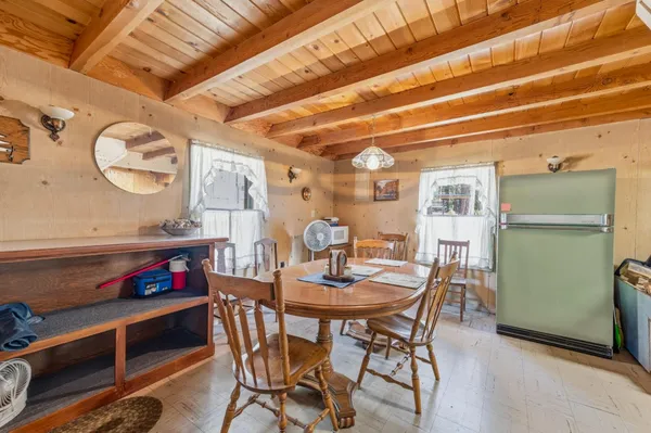 a view of a dining room with furniture and a chandelier