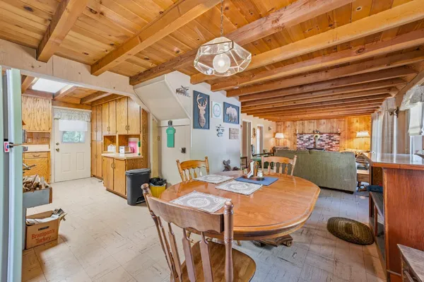 a dining room with furniture and wooden floor