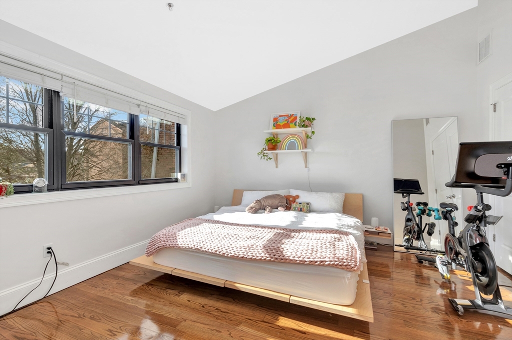 27 Dudley Street Boston, MA 02119 - Photo 11 of 42 a bedroom with a bed and wooden floor