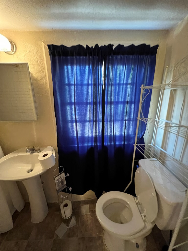 5820 1/2 Dearborn Avenue Columbus, GA 31909 - Photo 2 of 11 a bathroom with a sink toilet and shower