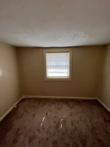 an empty room with a empty space and a window