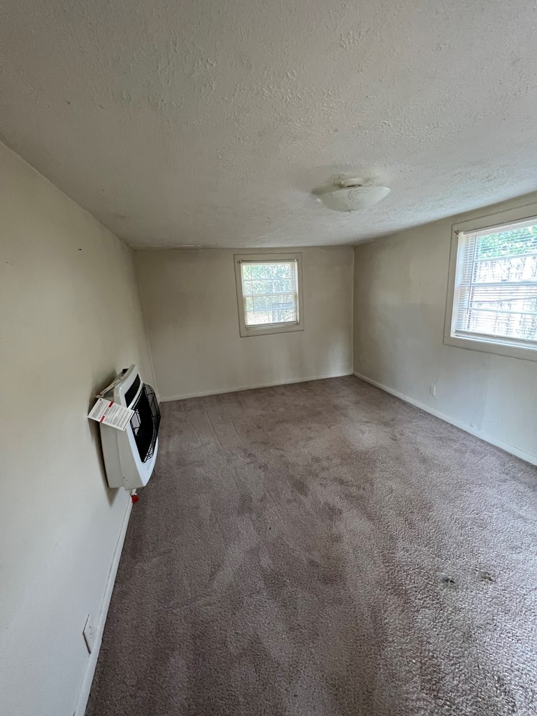 5820 1/2 Dearborn Avenue Columbus, GA 31909 - Photo 9 of 11 an empty room with windows and cabinet