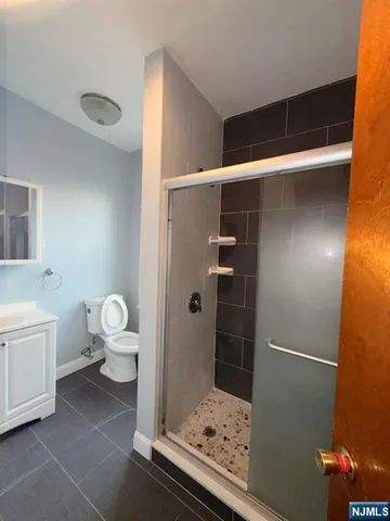 a bathroom with a toilet and a shower