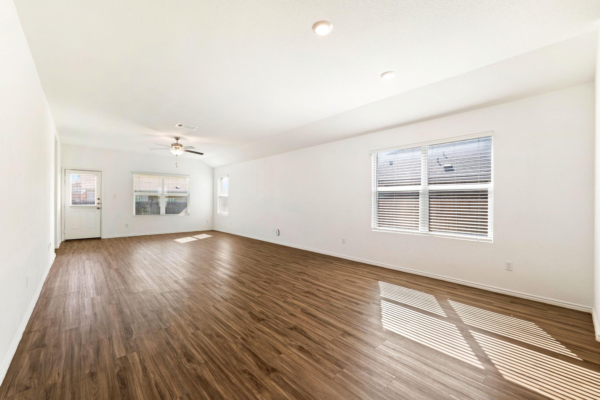 133 Konik Road Georgetown, TX 78626 - Photo 6 of 29 an empty room with wooden floor and windows