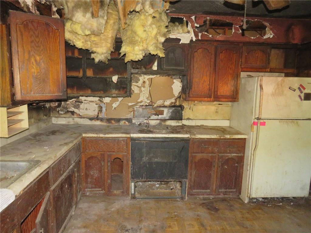 110 Tate Road Hookstown, PA 15050 - Photo 14 of 26 a kitchen with granite countertop a sink and a refrigerator