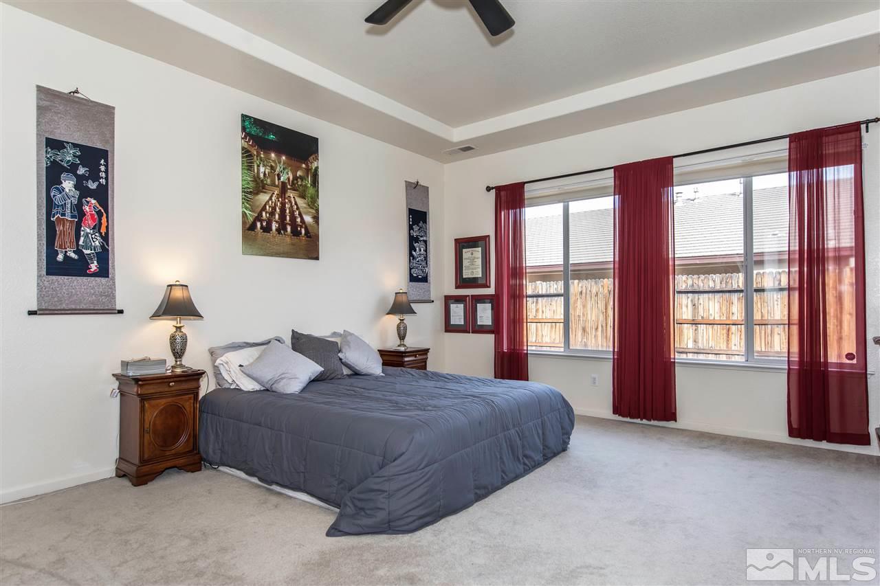 1675 Greycrest Way Reno, NV 89521 - Photo 13 of 25 a spacious bedroom with a large bed and a window