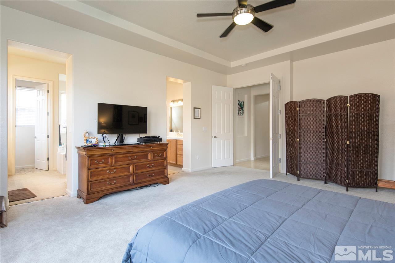 1675 Greycrest Way Reno, NV 89521 - Photo 14 of 25 a bed room with a bed a television and dresser
