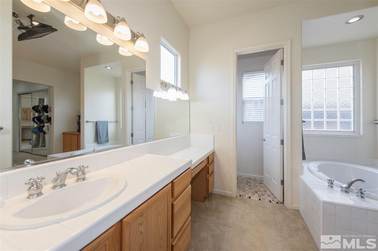 1675 Greycrest Way Reno, NV 89521 - Photo 15 of 25 a spacious bathroom with a sink double vanity granite tub and a mirror