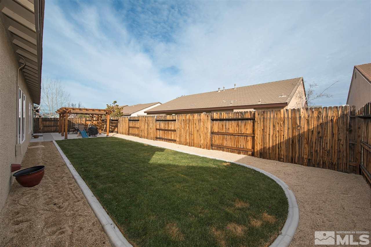 1675 Greycrest Way Reno, NV 89521 - Photo 18 of 25 a backyard of a house with lots of green space