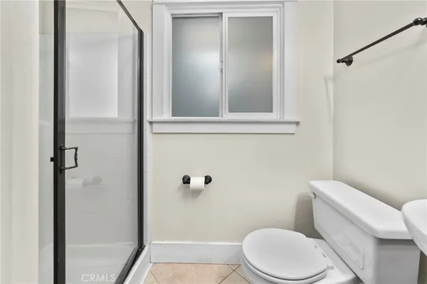 a white toilet sitting next to a bathroom sink