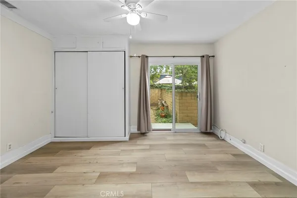 a view of an entryway with a floor to ceiling window and a ceiling fan