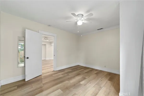 a view of a room with wooden floor