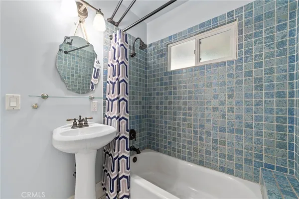 a bathroom with a sink a bathtub and shower