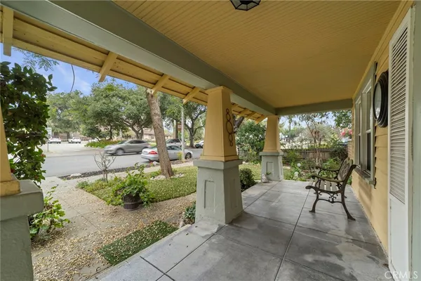 a view of a porch with furniture and a yard